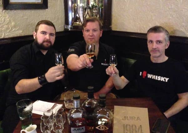 Sean Murphy, left, with Frank Murphy, middle, and Mark Connelly, right, enjoy the newest offering from Jura, the 1984. Picture: Sean Murphy