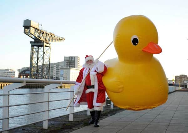 Santa Claus successfully hooks the hefty duck. Picture: Hemedia