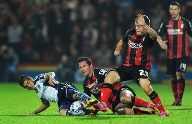 Ryan Fraser (No 20) tries to nick the ball away from West Broms Christian Gamboa. Picture: Getty Images