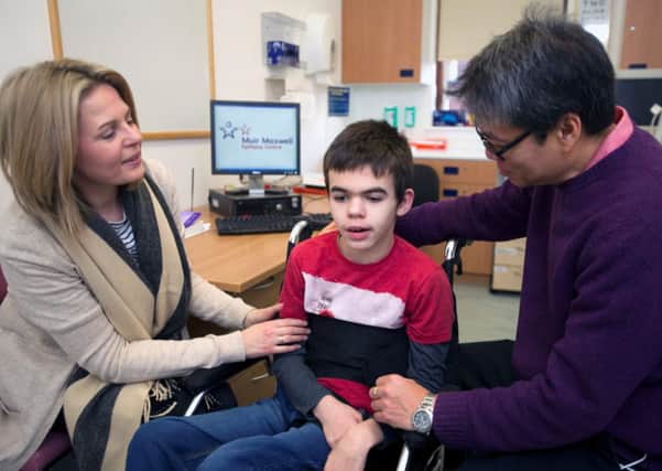 Lorraine Robertson with son Max aged 12 (who is taking part in the trial) and Dr Richard Chin. Picture: Jane Barlow