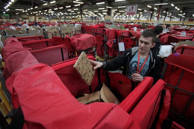 Workers sort mail in the Royal Mail St Rollox sorting office in Glasgow. Picture: Hemedia