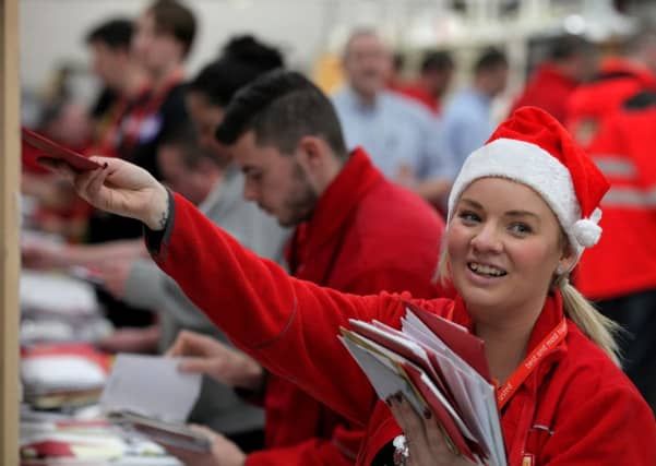 Postal worker Paula Burnside sorts out mail by hand in the Royal Mail St Rollox sorting office in Glasgow. Picture: Hemedia