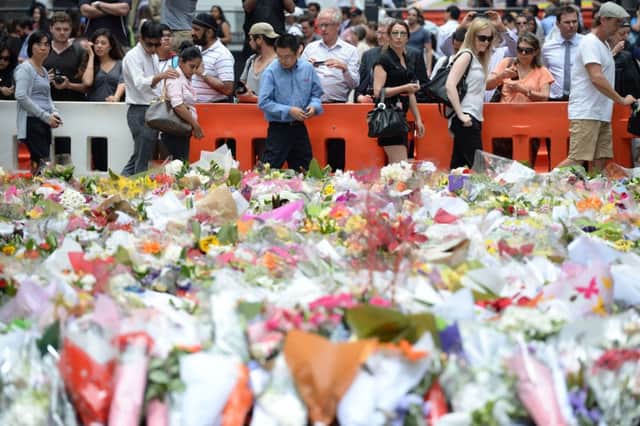 Thousands poured into downtown Sydneys Martin Place yesterday, the scene of the siege where two hostages died. Picture: Getty
