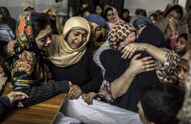 Grief and anguish show on the faces of these women mourning their relative, Mohammed Ali Khan, 15. Picture: Reuters