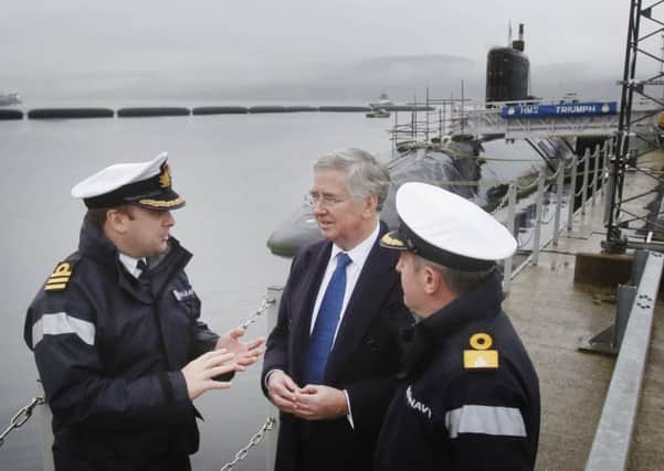 Michael Fallon (centre) during a visit to HM Naval Base Clyde. Picture: PA