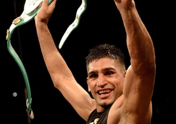 Amir Khan celebrates his unanimous points victory over Devon Alexander, at The MGM Grand Garden Arena in Las Vegas. Picture: Getty