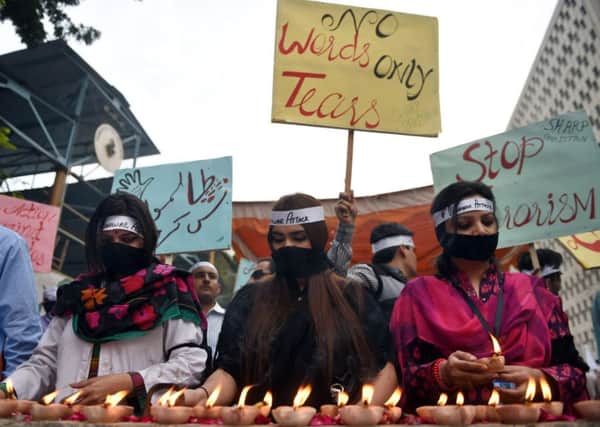 Human rights activists in Karachi light candles in memory of the school attack victims. Picture: Getty Images