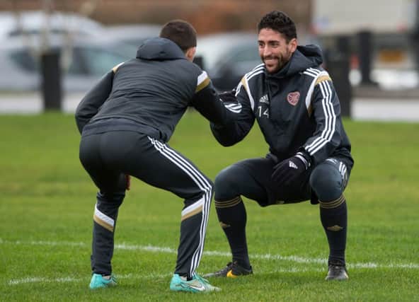 Miguel Pallardo, right, stretches during Hearts training at Riccarton yesterday. Picture: Rob Casey/SNS
