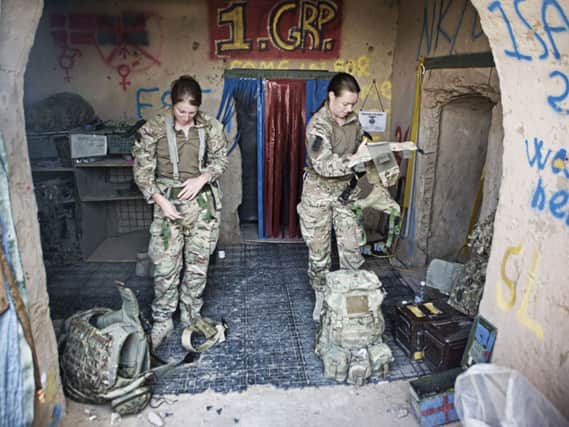 Female British soldiers remove their equipment after returning from patrol in Afghanistan: Alison Baskerville/LNP