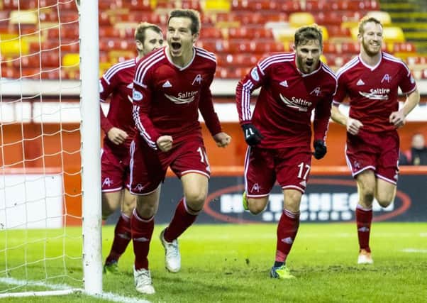 Aberdeen's Peter Pawlett (second from left) celebrates scoring his goal with team-mates. Picture: SNS