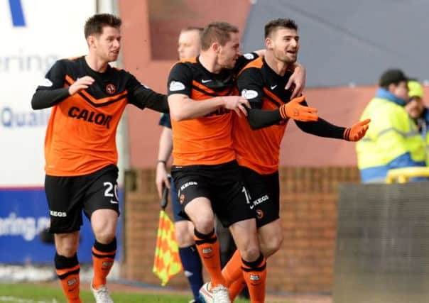 Dundee Utd's Nadir Ciftci (right) wheels away after netting against Celtic. Picture: SNS