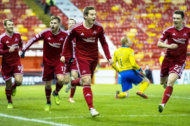 Peter Pawlett, centre, leads his Aberdeen team-mates in celebration after scoring the only goal of the game. Picture: SNS Group