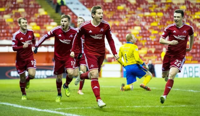 Peter Pawlett, centre, leads his Aberdeen team-mates in celebration after scoring the only goal of the game. Picture: SNS Group