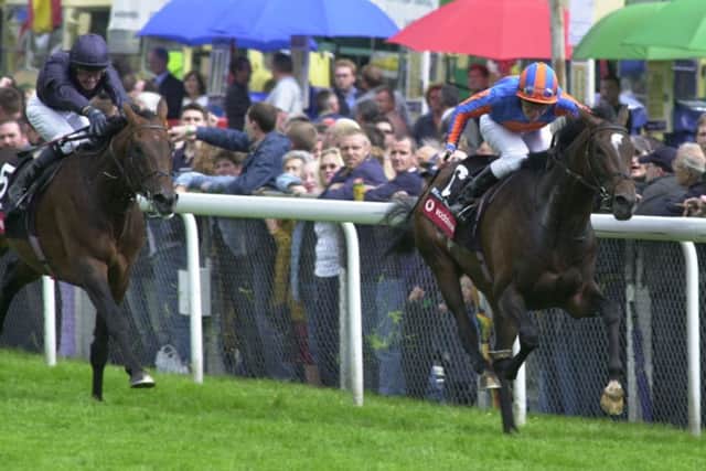 High Chaparral, right, ridden by Johnny Murtagh, wins the 2002 Derby, from Hawk Wing. Picture: PA