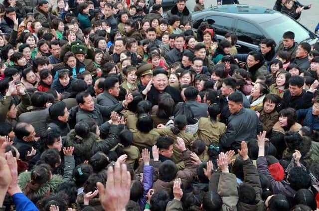 The Norths leader Kim Jong-Un, centre, is furious at allegations his regime hacked Sonys computer systems. Picture: AFP/Getty