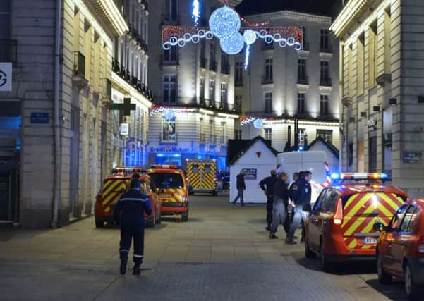 Police in Nantes stand on the site where the driver of a van ploughed into a Christmas market injuring at least ten people before stabbing himself. Picture: Getty