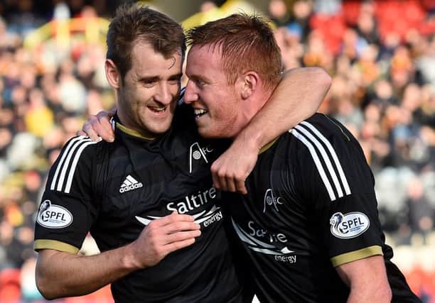Aberdeens Niall McGinn, left, and Adam Rooney, who have both signed new contracts at Pittodrie, celebrate a goal. Picture: SNS