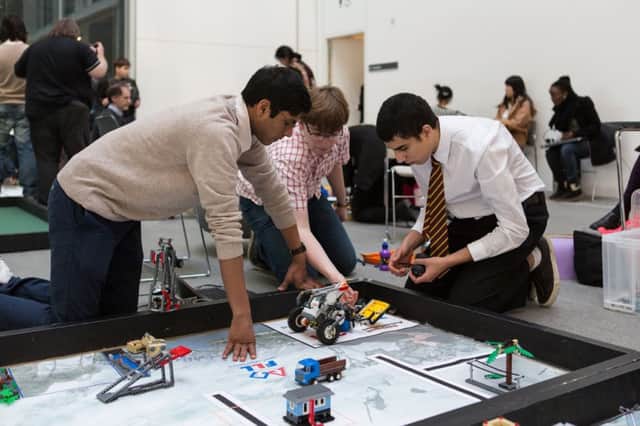 School students at a First Lego League event, where they are challenged to design robots