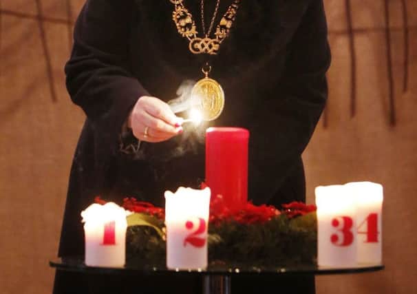 Glasgow Lord Provost Sadie Docherty lights a candle during a service of remembrance at St George's Tron Church. Picture: Getty