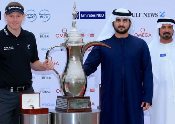 Shaikh Maktoum bin Mohammed bin Rashid Al Maktoum, Deputy Ruler of Dubai, presents  the 2014 winners trophy to Stephen Gallacher. Picture: Golf in Dubai