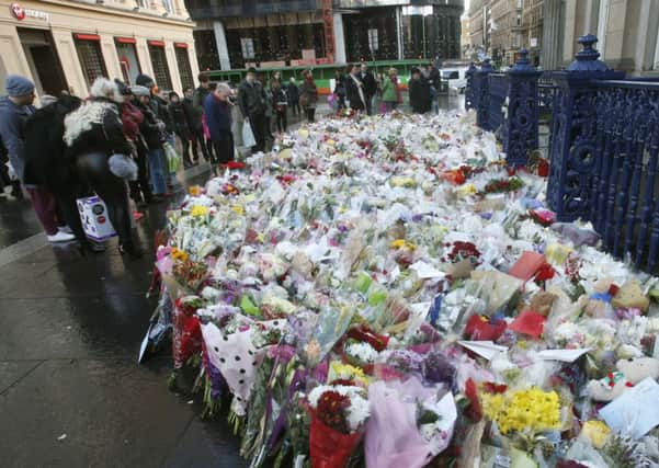 Floral tributes near the Gallery of Modern Art in Glasgow where a bin lorry lost control and killed six people. Picture: PA