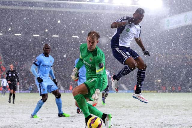Manchester City goalkeeper Joe Hart retrieves the ball under pressure from Brown Ideye of West Brom. Picture: Getty
