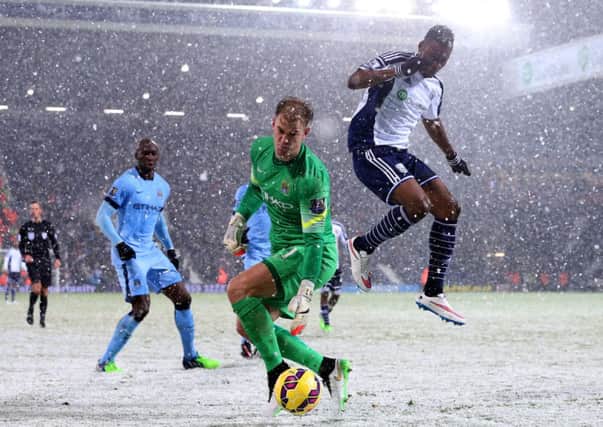 Manchester City goalkeeper Joe Hart retrieves the ball under pressure from Brown Ideye of West Brom. Picture: Getty