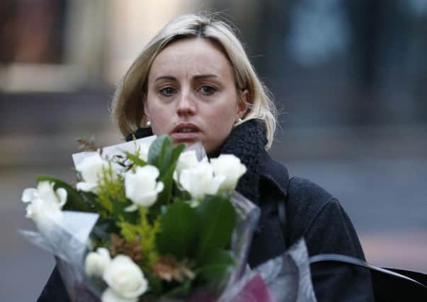 A well-wisher brings flowers to the accident scene. Picture: Reuters
