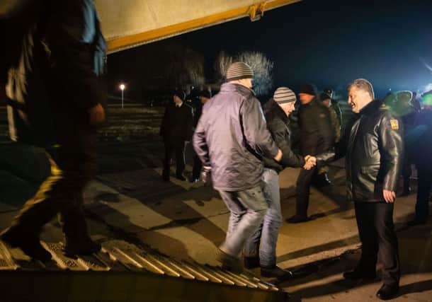 Ukrainian president Petro Poroshenko, right, welcomes freed Ukrainian troops near Kiev. Picture: AFP
