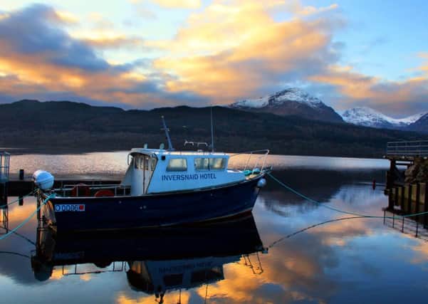 Snow covered mountain tops are seen behind Loch Lomond in the view from Inversnaid Hotel. Picture: hemedia