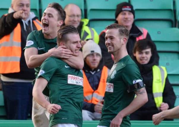 Scott Allan (left) and Danny Handling (right) congratulate Jason Cummings after the striker made it 2-0. Picture: SNS