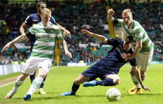 Celtic strikers Leigh Griffiths, left, and John Guidetti battle for the ball with Ross County's Paul Quinn. Picture: SNS