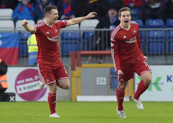 Aberdeen's Peter Pawlett charges off to celebrate his goal with Ryan Jack (left). Picture: SNS