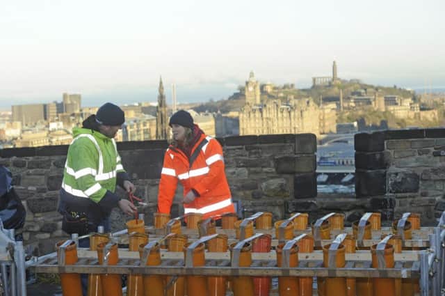 Shaun Gibson  and Sarah Gardiner prepare the fireworks for the Hogmanay display. Picture: Greg Macean