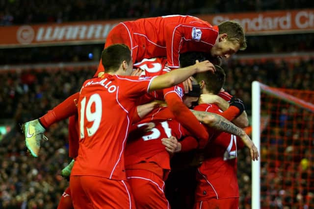Liverpool players mob Adam Lallana. Picture: Getty