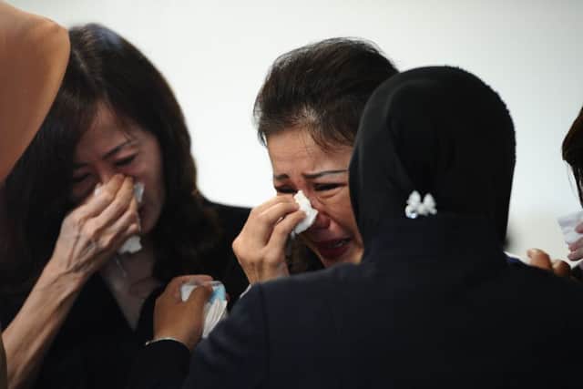 Grieving relatives of missing AirAsia flight QZ8501 passengers at the crisis centre of Juanda International Airport Surabaya. Picture: Getty