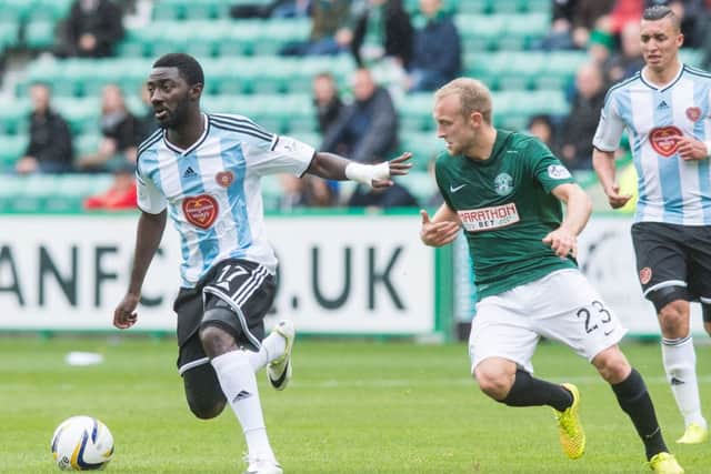 Prince Buaban holds off Hibernian's Dylan McGeouch in the Edinburgh derby. Picture: Ian Georgeson