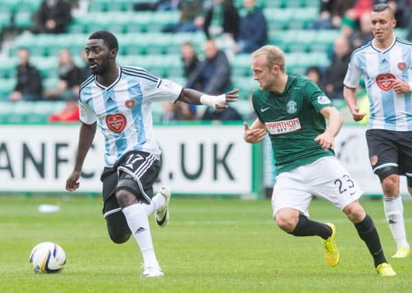 Prince Buaban holds off Hibernian's Dylan McGeouch in the Edinburgh derby. Picture: Ian Georgeson