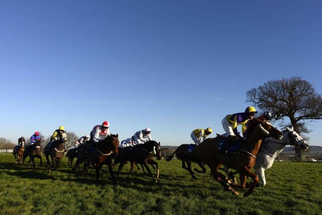 Runners race down the back straight under a clear blue sky at Taunton yesterday. Picture: Getty