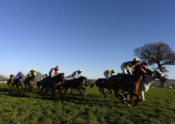 Runners race down the back straight under a clear blue sky at Taunton yesterday. Picture: Getty