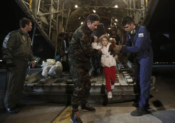 Five-year-old rescued passenger Serafina Gondolo arrives from Italy at Elefsina Air Base. Picture: AP