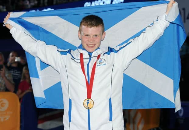 Charlie Flynn, who turned out to be one of the faces of Glasgow 2014, with his medal. Picture: Lisa Ferguson