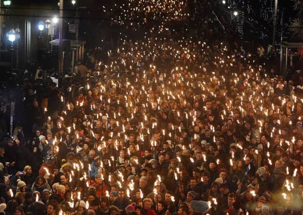 Crowds gathered at the City Chambers to mark the beginning of the Torchlight procession. Picture: Neil Hanna