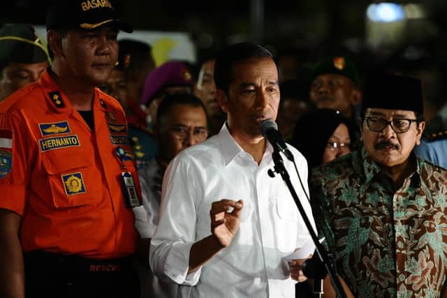 Indonesia's President Joko Widodo (C) speaks during press conference at AirAsia crisis center. Picture: Getty