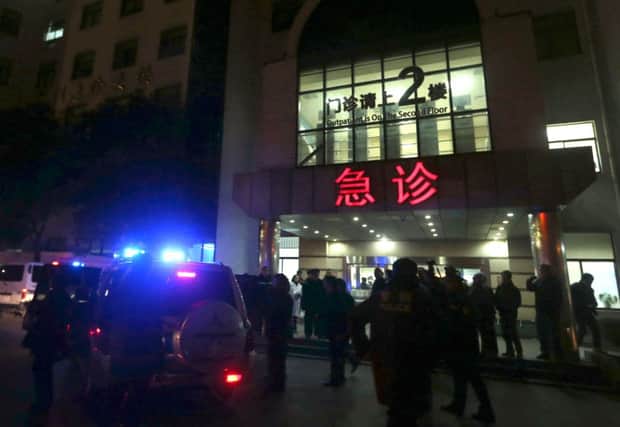 Medical workers stand outside the emergency ward of the No. 1 People's Hospital of Shanghai. Picture: AP
