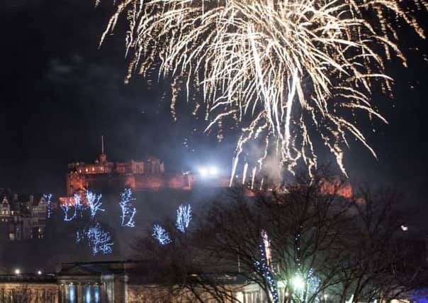 Fireworks from the ramparts of Edinburgh Castle light up Scotland's capital to mark the start of 2015. Picture: Jane Barlow