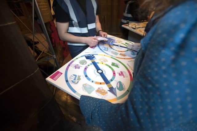 Audience members spin the compass wheel to determine which venue they visit during the Scot:Lands event. Picture: Jane Barlow