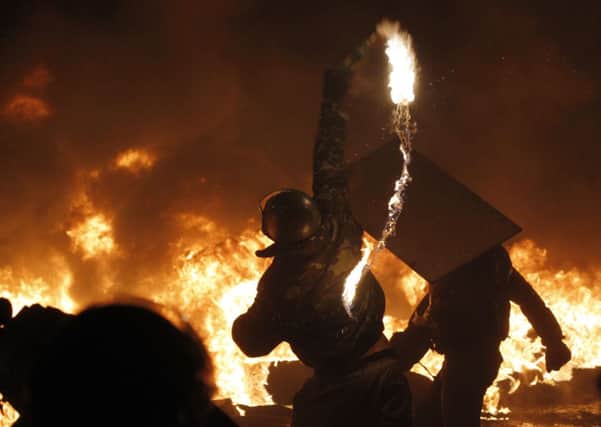 A protester throws a Molotov cocktail during riots in Kiev. Picture: AP