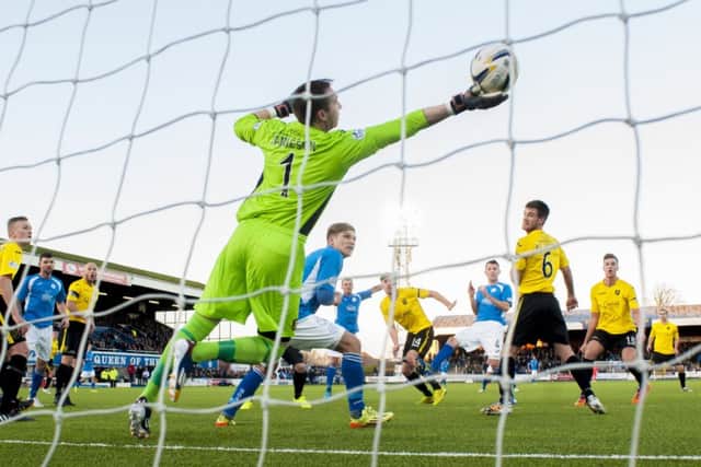Andy Dowie heads past Livi keeper Darren Jamieson. Picture: SNS