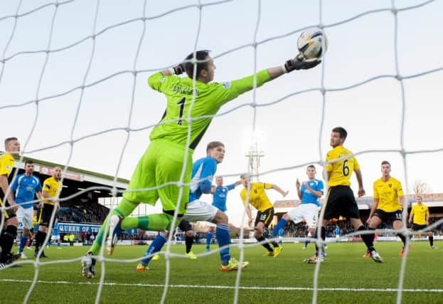 Andy Dowie heads past Livi keeper Darren Jamieson. Picture: SNS